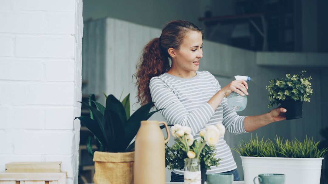 woman caring for indoor plants